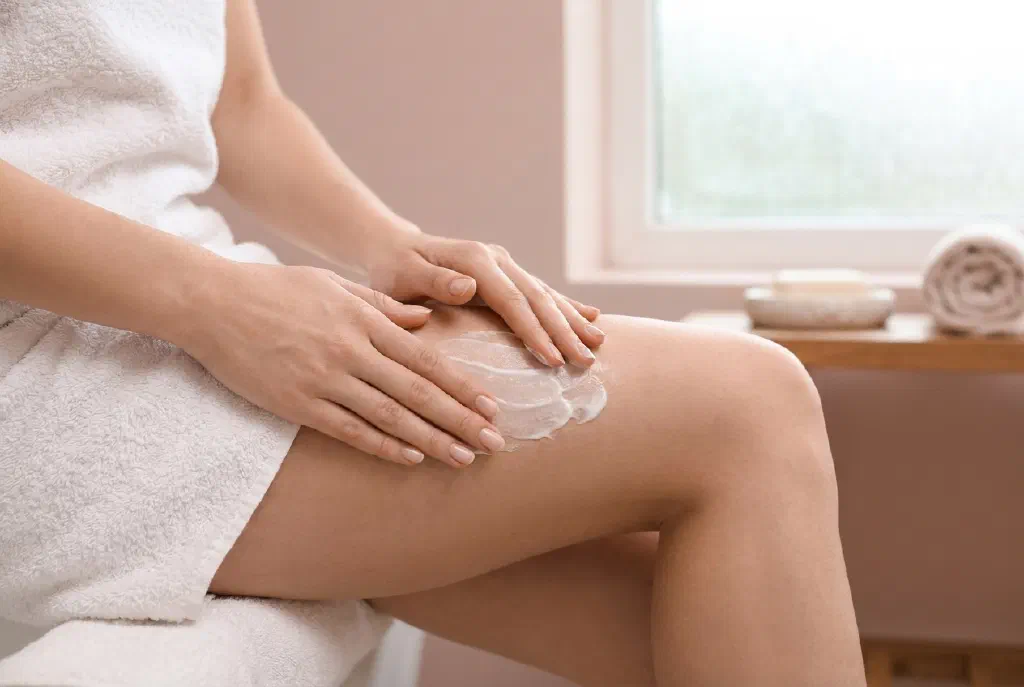 Hands massaging the thigh skin for cellulite treatment