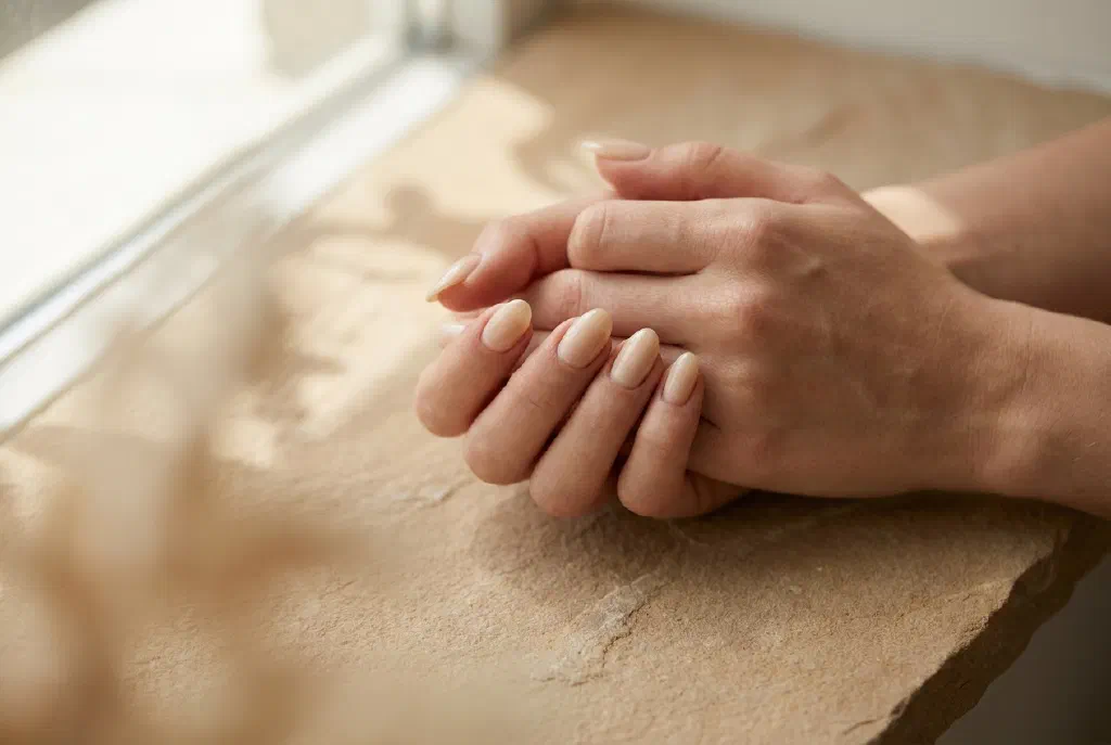 Well-groomed nails in a soft nude shade with a delicate shine