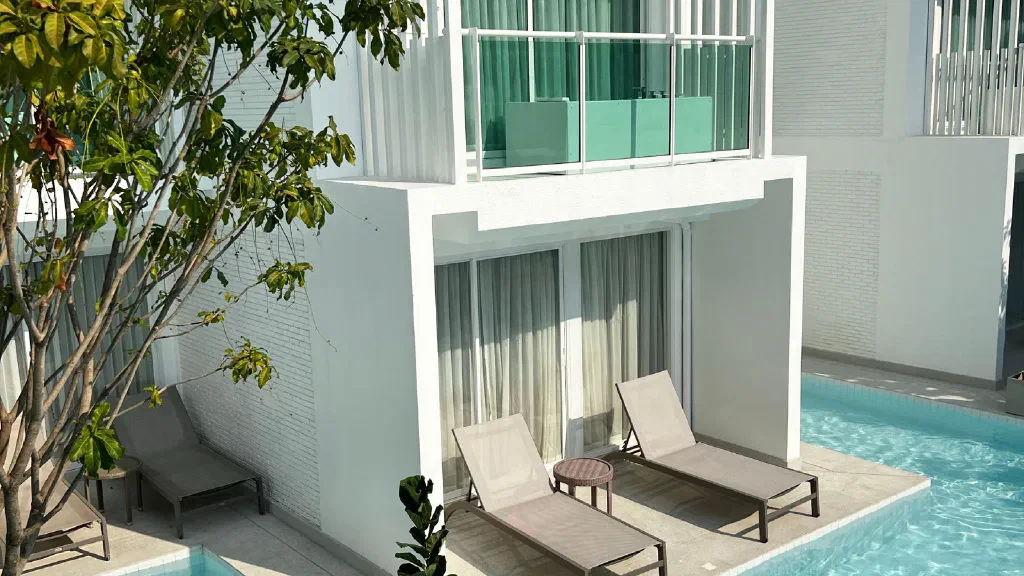Dog lying relaxed on a blanket in front of a cozy wellness hotel